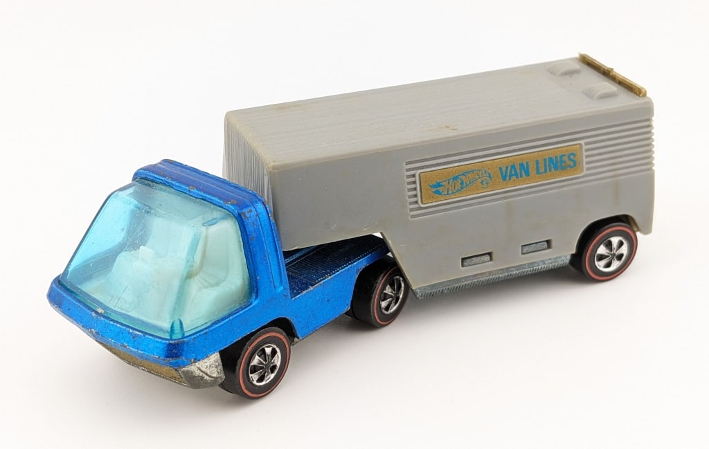 Hot Wheels Redline Blue Cab Moving Van: Hot Wheels Redline The Heavyweights blue cab moving van with gray trailer. The truck has some scattered micro chips and edge wear.
