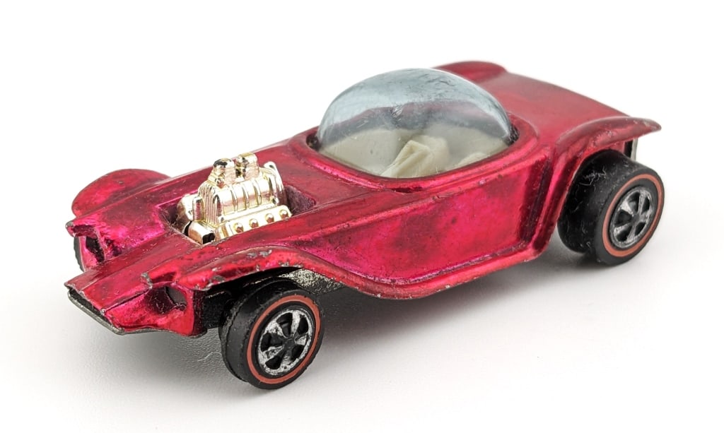 Hot Wheels Redline Pink Beatnik Bandit - U.S.: Hot Wheels Redline pink U.S. Beatnik Bandit. The car has toning, edge wear, dullness to the base, and age wear.