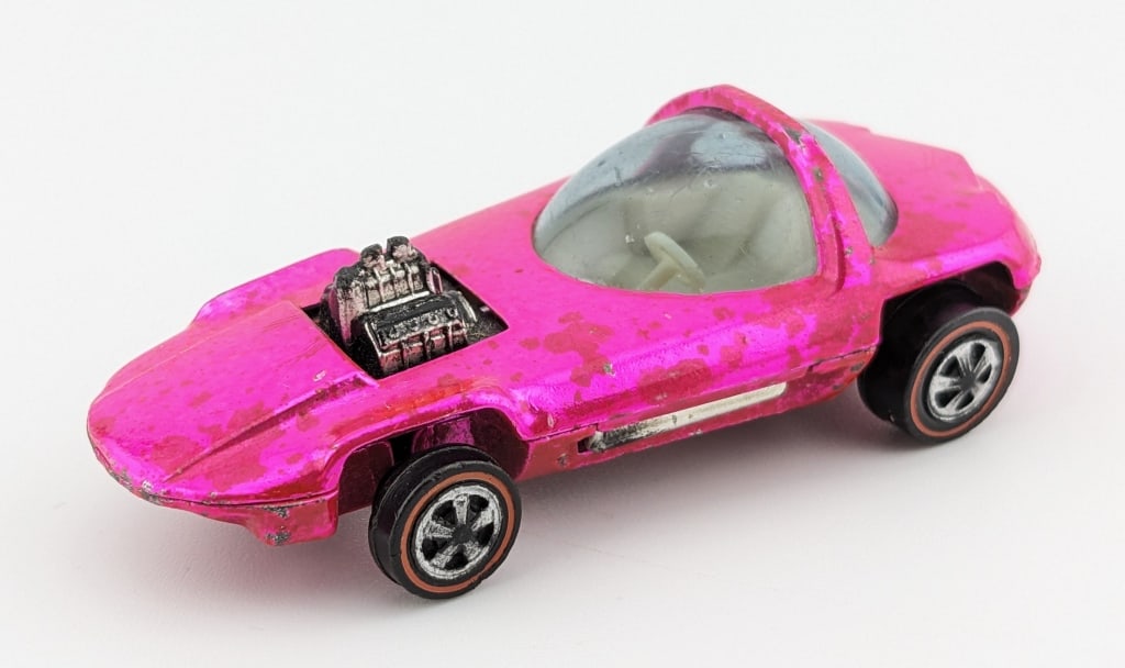 Hot Wheels Redline Hot Pink Silhouette - U.S.: Hot Wheels Redline United States hot pink Silhouette car. The car has paint toning, black engine, white interior, surface scratches, and wear from age.