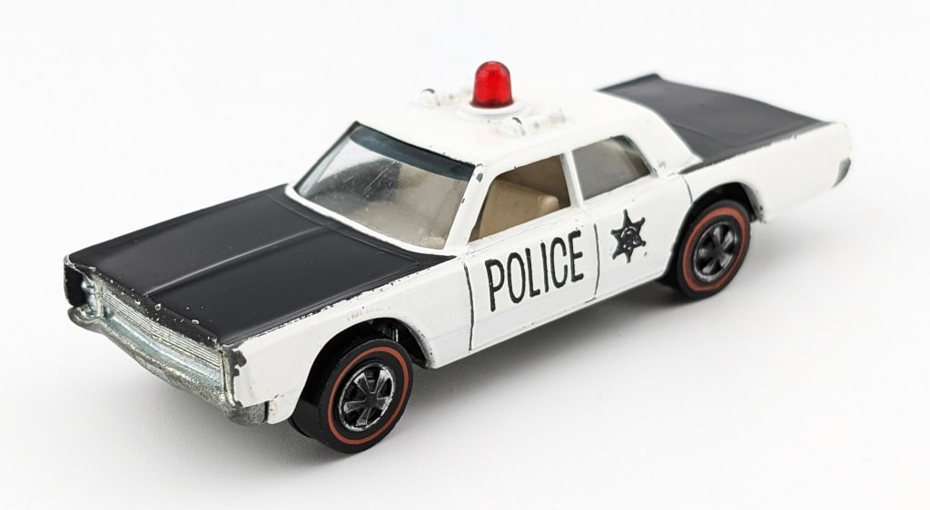Hot Wheels Redline Police Cruiser w/ Translucent: Hot Wheels Redline Police Cruiser with translucent red siren. The car has some high edge wear, and a couple small micro chips. The car has a shiny toned base.