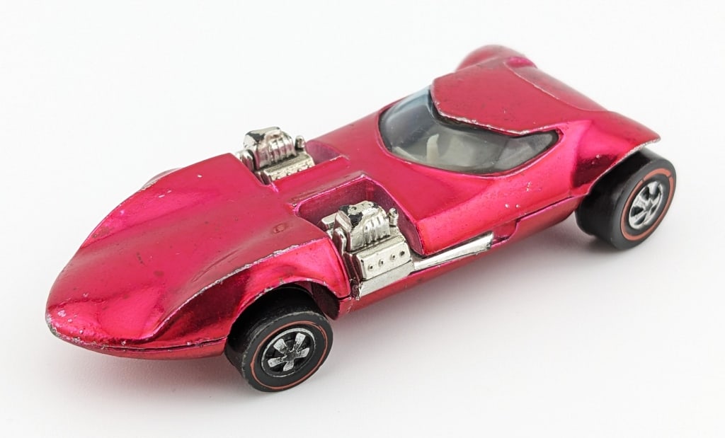 Hot Wheels Redline Pink Twin Mill: Hot Wheels Redline pink Twin Mill with white interior. The car has some toning on the rear, edge wear, and yellowing to the passenger side engine.