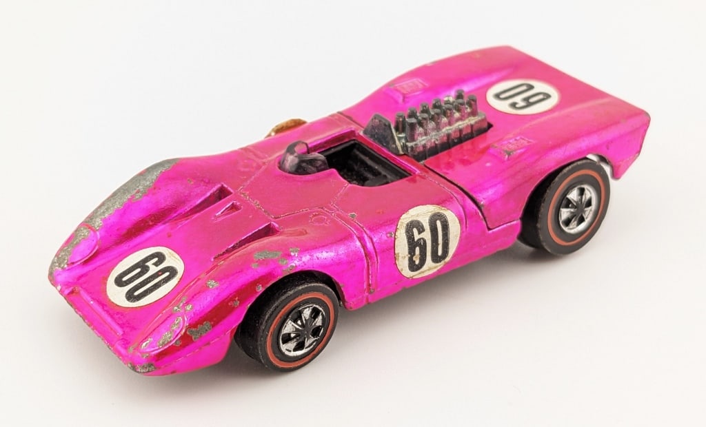 Hot Wheels Redline Hot Pink Ferrari 312P - U.S.: Hot Wheels Redline U.S. hot pink Ferrari 312P. The car has paint loss to the front fenders, micro chips, toning, and wear from age.