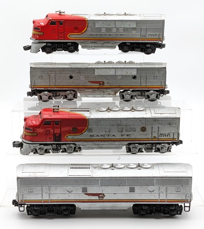 Lionel Santa Fe #2243 & #2343 Santa Fe Engines: Lionel O-Gauge #2243 engine and #2343 dummy engine with b units. All have paint loss, scratches, and wear from play / age.