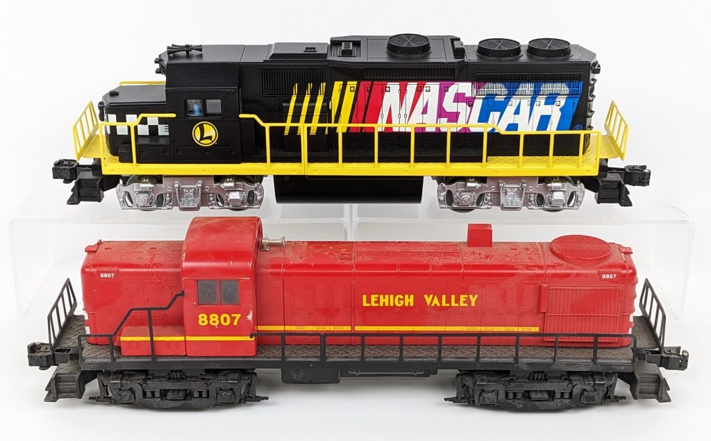 Lionel #8807 L.V. RS-3 Diesel & Nascar Engine: Lionel O Gauge #8807 Lehigh Valley RS-3 diesel engine and Nascar engine. The #8807 has some paint chips, dust, and wear from display. The Nascar engine is nice.