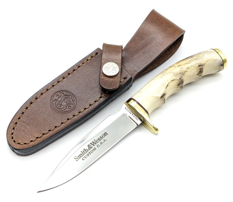 Smith & Wesson Custom Stag Finger Groove Knife: Smith & Wesson Custom Stag Finger Groove Knife w/ Sheath. Knife features a mirror polished blade with thumb groove, brass single downturned guard, stag finger groove handle, and brass buttcap. Knife i