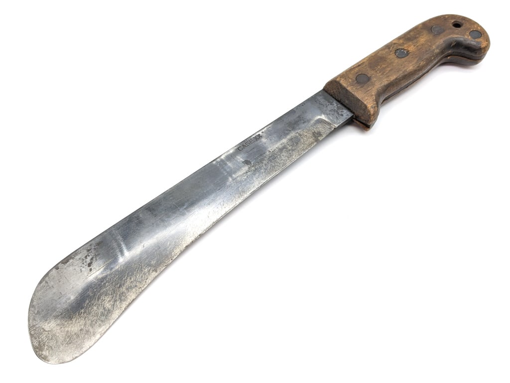 WW2 Case XX Pilot Survival Machete: WW2 Case XX Pilot Survival Machete. Features a bolo style blade, and wooden handle scales. Knife is in used condition with scratches and sharpening marks on the blade, and various dings on the handle.