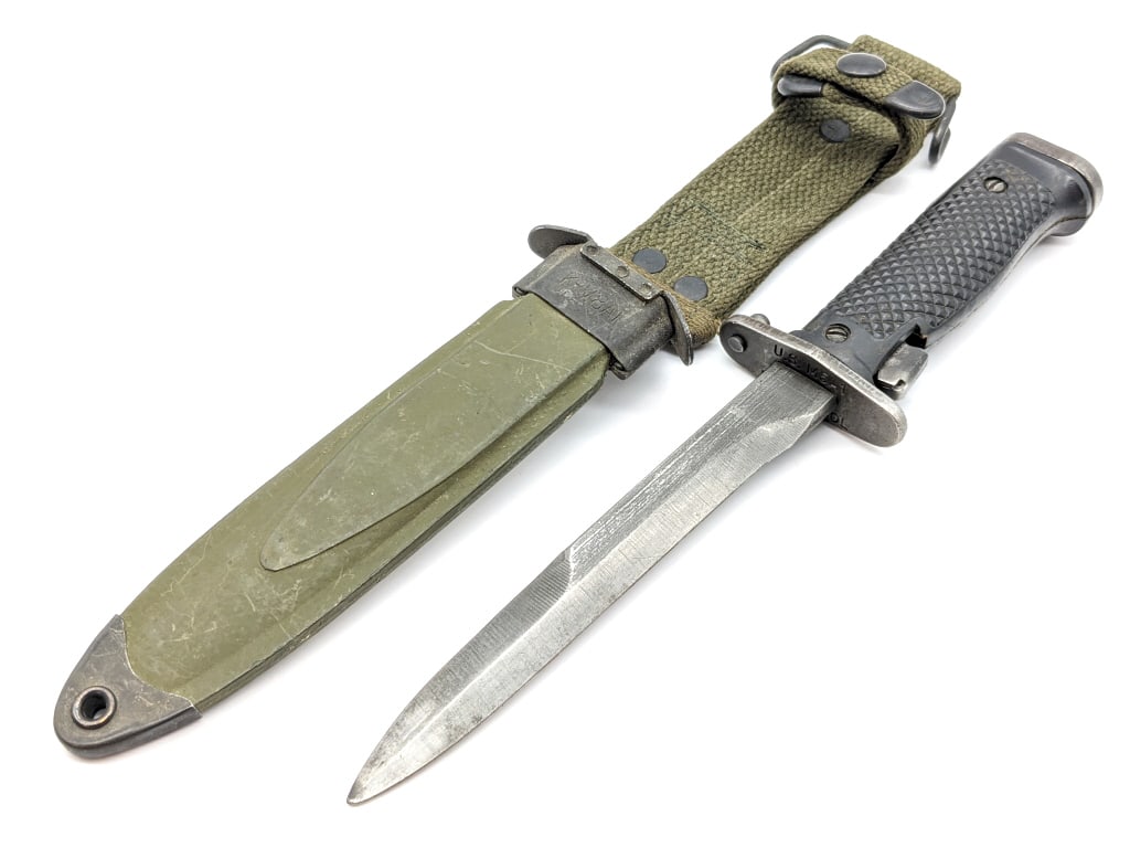 US Milpar Col M5A1 M1 Garand Bayonet & Scabbard: US Milpar Col M5A1 M1 Garand Bayonet & Scabbard. Features a blackened steel blade, double guard, and checkered plastic handle. Knife is in used condition with material loss on the blade from sharpenin
