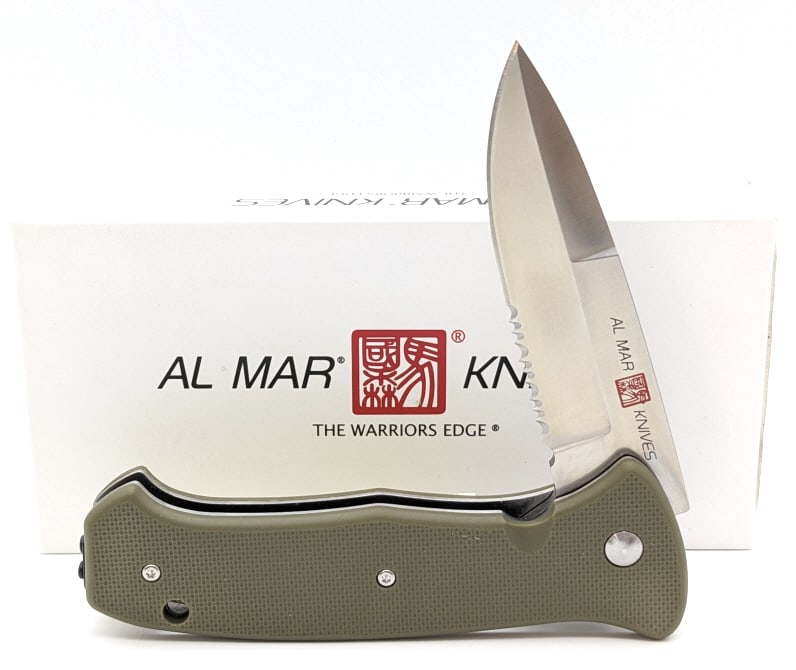 NIB Al Mar SERE 2020 Assisted Open Folding Knife: NIB Al Mar SERE 2020 Assisted Open Folding Knife AMK2211 OD Green Series. Features a partially serrated spear point blade, and OD Green G-10 handle scales. Overall length of 5in when closed.