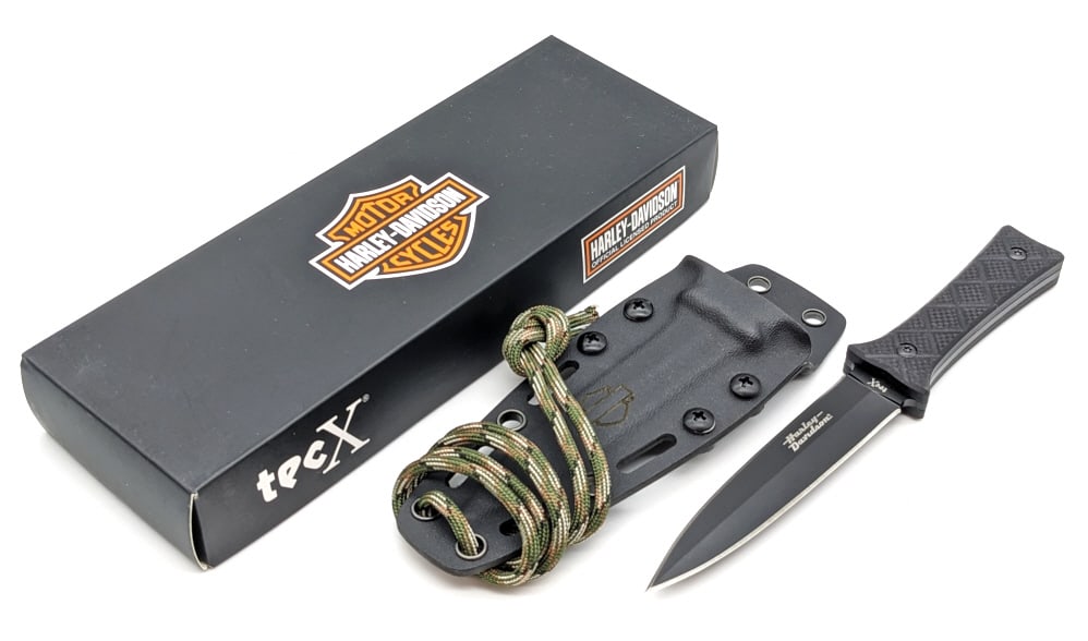 NIB Tec X Harley-Davidson Fixed Blade Neck Knife: NIB Tec X Harley-Davidson Fixed Blade Neck Knife. Features a black finish spear point blade, black G-10 handle scales, and kydex sheath. Comes with paracord. Blade length of 4in and overall length of