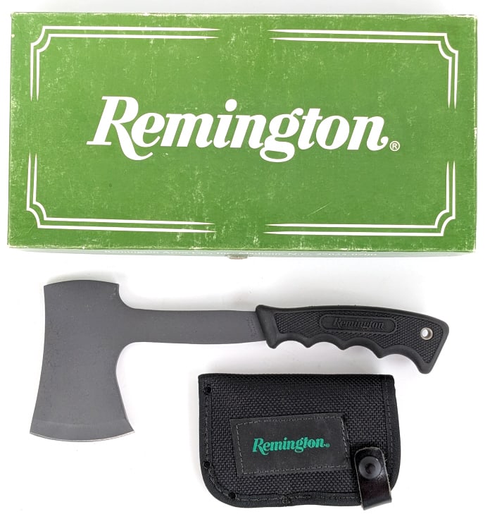 NIB Remington 18578 Camp Hatchet w/ Sheath: NIB Remington 18578 Camp Hatchet w/ Sheath. Features a darkened metal blade and rubber handle. Blade length of 3in and overall length of 11in.