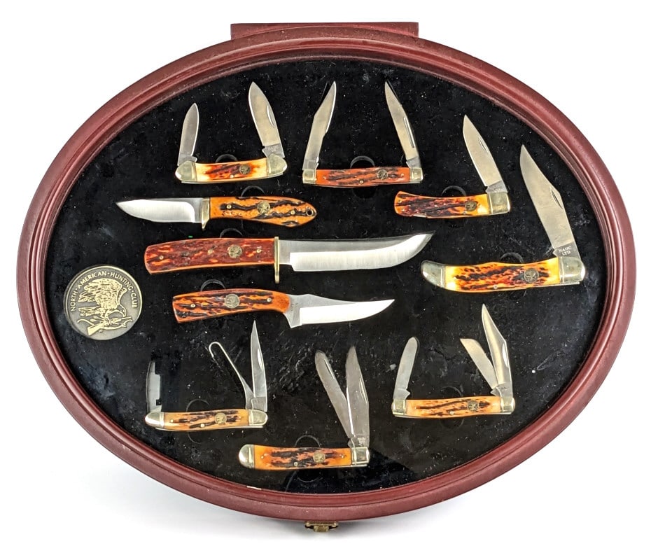 North American Hunting Club Knife Set w/ Case: North American Hunting Club Knife Set w/ Case. Pieces feature jigged amber bone handles and includes various style fixed blades and folding knives. Knives are in very nice condition with light tarnish