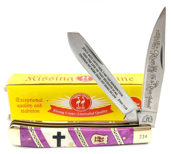 Kissing Crane Christ is Risen Purple Bone Trapper: Kissing Crane Christ is Risen Purple Bone Trapper w/ Box. Knife is numbered 234 on the upper front bolster and features purple and white bone handle scales, nickel silver spacers, and Jesus Christ bla