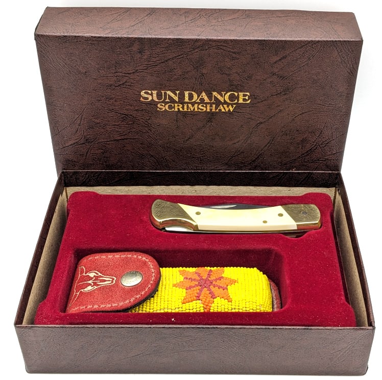 Schrade Ltd Scrimshaw Lockback Folding Hunter: Schrade Ltd Scrimshaw Lockback Folding Hunter w/ Sheath & Box. Knife features synthetic white handle scales and comes with a longhorn beaded leather sheath. Knife is in very nice condition with tarnis