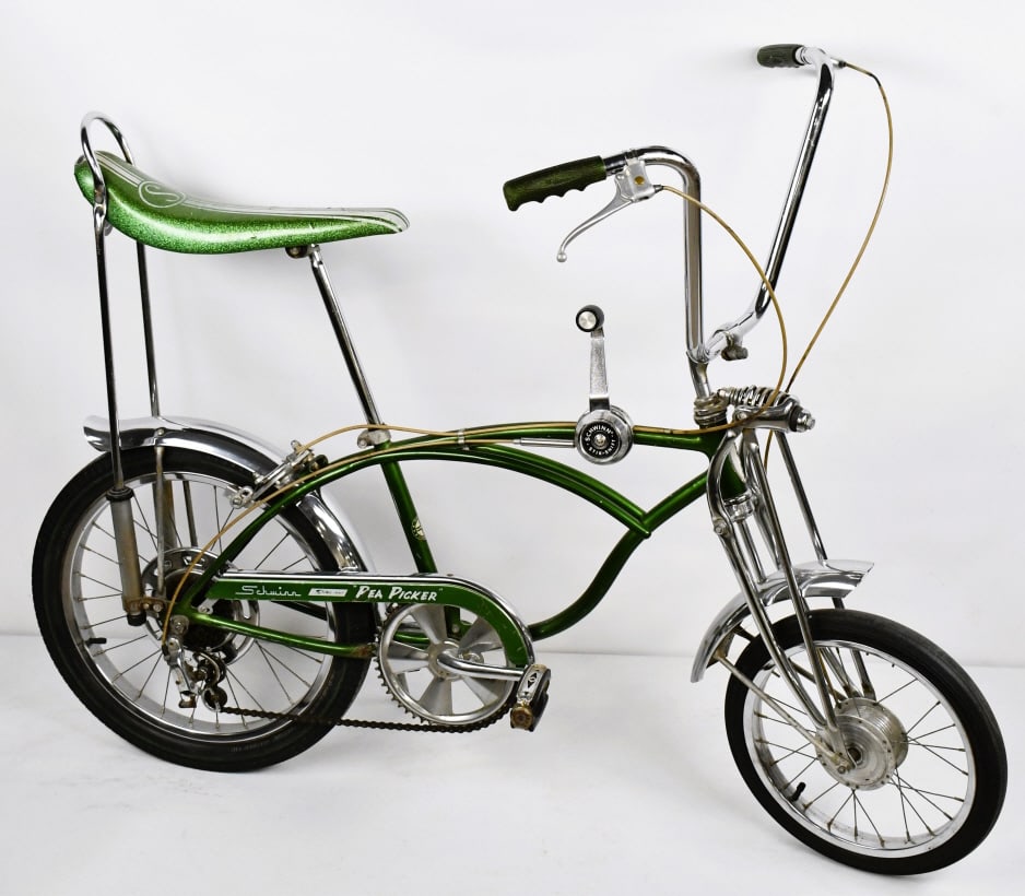 1969 Schwinn Sting-Ray Pea Picker Krate Bicycle: 1969 Schwinn Sting-Ray Pea Picker Krate Bicycle. The bike has a banana seat, Schwinn Stik Shift, and a Sting-Ray Gripper Slik rear tire. The seat has a tear, scratches on the frame, and wear from use 