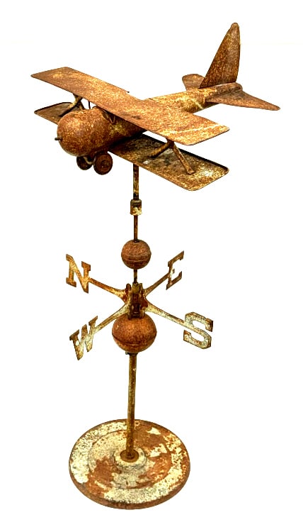 Vintage Metal Bi-Plane Weathervane: Vintage Metal Bi-Plane Weathervane. This Weathervane Is On A Steel Stand. The Airplane and Directional Arrows Spin Freely. The Prop Is Missing From The Plane. It Is Weathered and Shows Oxidation. The 