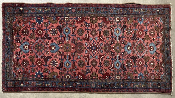 Antique Persian 79" x 42" Area Rug: Antique Persian wool area rug. Measures approximately 79" x 42" and is in good condition with some use wear, a section of the side trim is detached.
