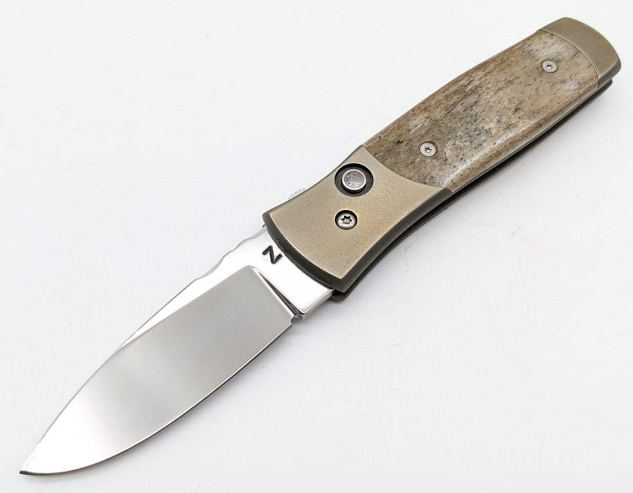 Z Custom Knives Giraffe Bone Switchblade Auto Knife: Z Custom Knives Giraffe Bone Switchblade Auto. Knife features a mirror polished drop point blade, file work along the spine, anodized titanium handle, and giraffe bone inlay button and handle scales. 
