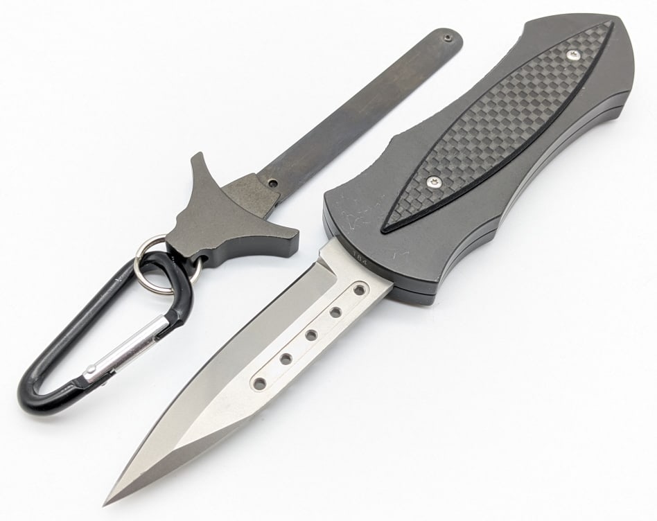 Phantom Knives OTF Neck Knife: Phantom Knives OTF Neck Knife. The knife operates by pulling on the end of the carabiner which pulls the blade outwards. Knife features a bead blast finish blade with a fuller, and black aluminum hand
