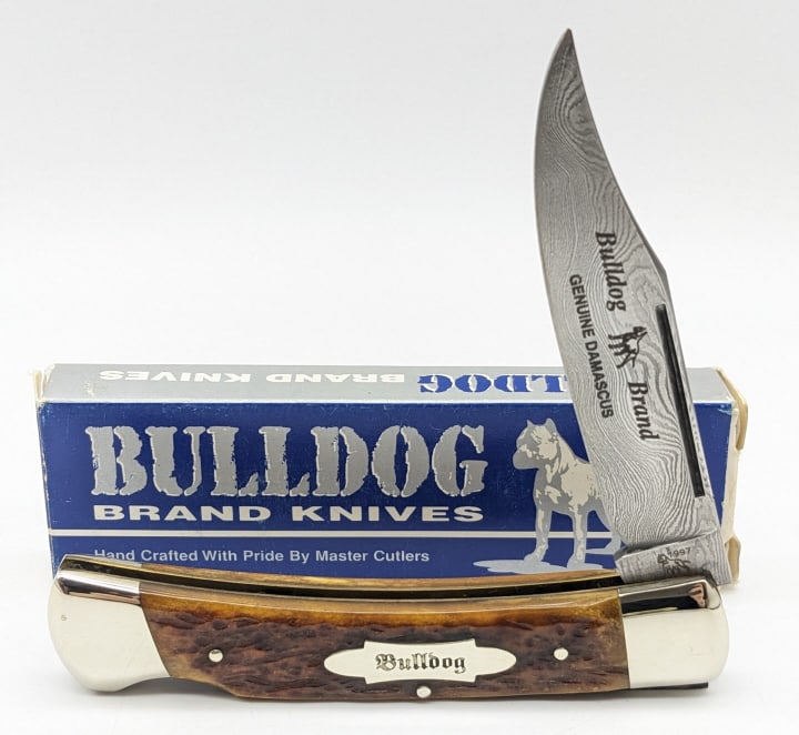 1997 Bulldog Brand Green Bone Damascus Knife 1 of 5: 1997 Ltd Bulldog Brand Antique Green Bone Damascus Lockback w/ Box. Knife is 1 of 5 and is in like new condition. Overall measures 4-3/8in when closed. Ref #: 294