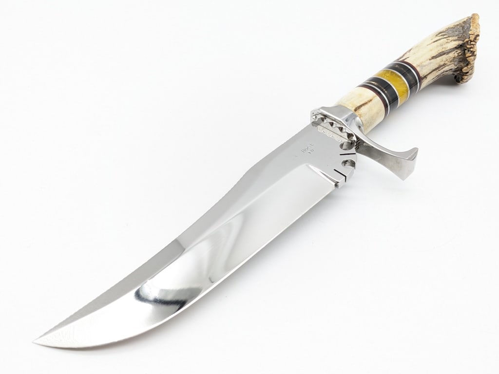 James "HOOT" Gibson Trailing Point Bowie Knife: James "HOOT" Gibson Trailing Point Bowie Knife. Features a large mirror polished trailing point blade with file work along the spine stamped HOOT 10 and 92, notched ricasso, mirror polished lug guard,
