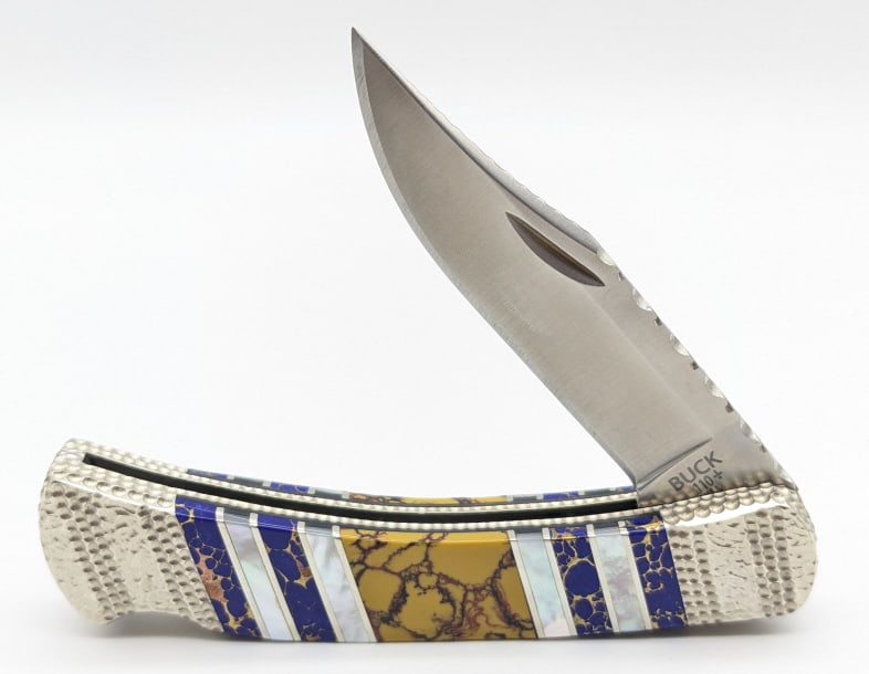 Custom Prater Mammoth Tooth Buck 110 Lockback Knife: Custom Michael Prater Mammoth Tooth Painted Pony Buck 110 Lockback Knife. Knife is numbered 22 and features file work on the spine and leaf spring, dimple engraving on the bolsters and spacers, and na