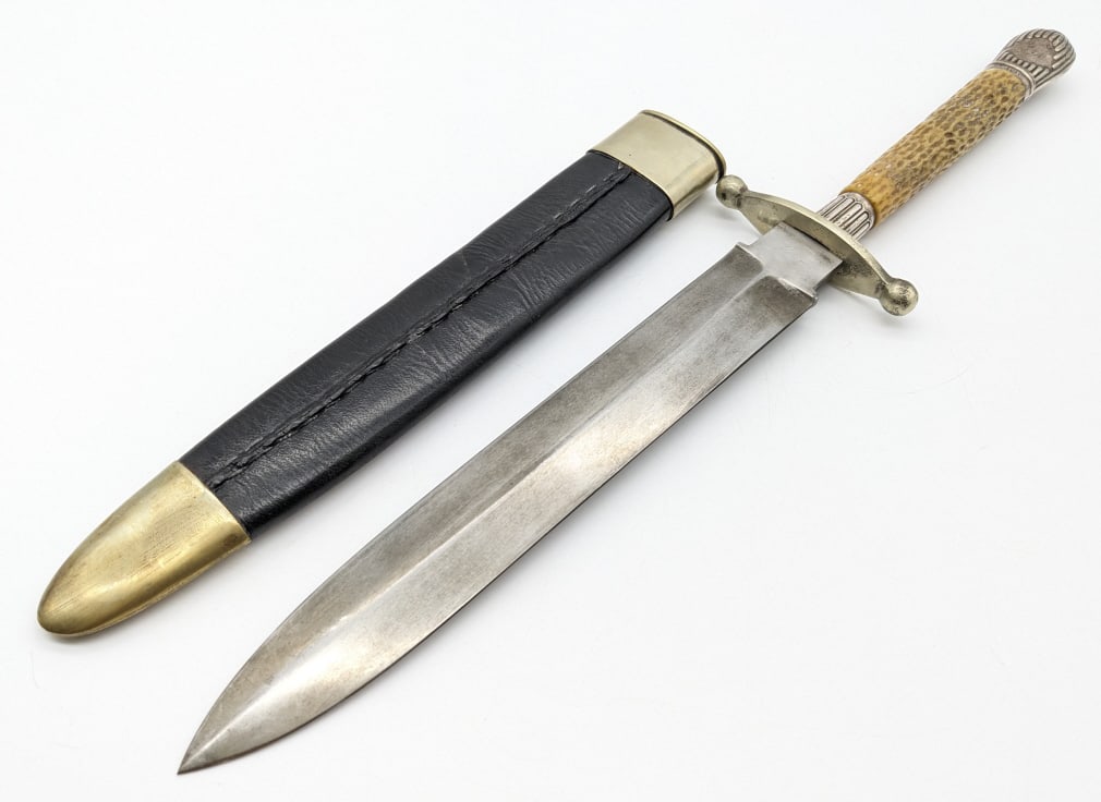 Mappin & Webb Sheffield Dagger w/ Sheath: Mappin & Webb Sheffield Dagger w/ Sheath. Reproduction knife features a double edged blade, ball point double guard, bone handle, and British sterling silver spacer and pommel. Knife is in very nice c