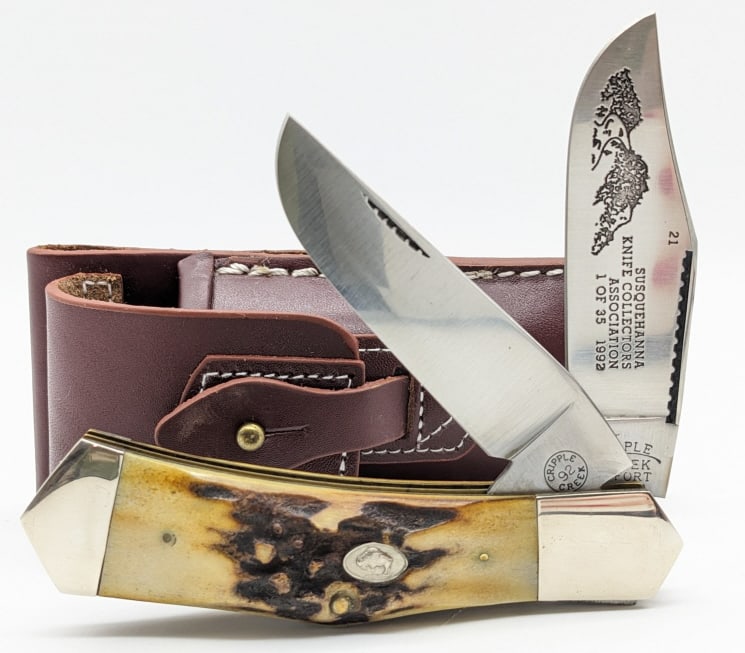 1992 Ltd Cripple Creek SKCA Stag Folding Hunter: 1992 Ltd Cripple Creek Susquehanna Knife Collectors Association Stag Folding Hunter w/ Sheath. Knife is number 21 of 35 and features etchings on the blade, and stag handle scales. Knife is in very nic