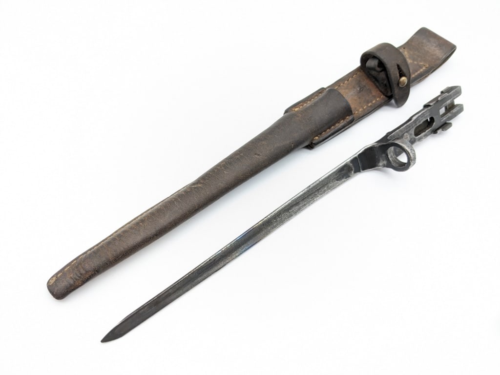 Rare Johnson Automatics 1941 Bayonet w/ Sheath: Rare Johnson Automatics 1941 Bayonet w/ Leather Sheath. Super rare bayonet that woudl pair perfect with lot 2015. Bayonet is marked A 5900 on the flat, and 3422 on the mounting ring. The leather sheat