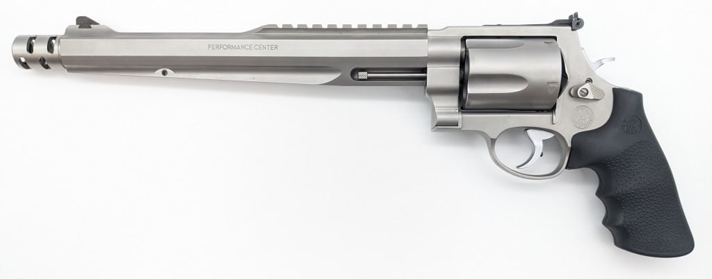Smith & Wesson Performance Center Mod 500 Revolver: Smith & Wesson Performance Center Model 500 S&W Revolver. Features a 10-1/2in barrel with muzzle break, adjustable rear sight, picatinny top rail, silver finish, and rubber grips. Revolver is in very