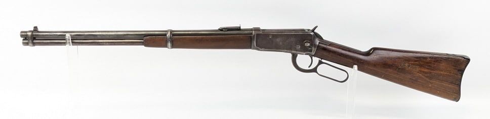 1914 Winchester Mod 94 .30 WCF Saddle Ring Carbine: 1914 Winchester Mod 94 .30 WCF Saddle Ring Carbine. Features a 20in barrel, worn blued finish, and smooth wood stock with initials carved into the left side of the butt. Rifle is in fair aged conditio
