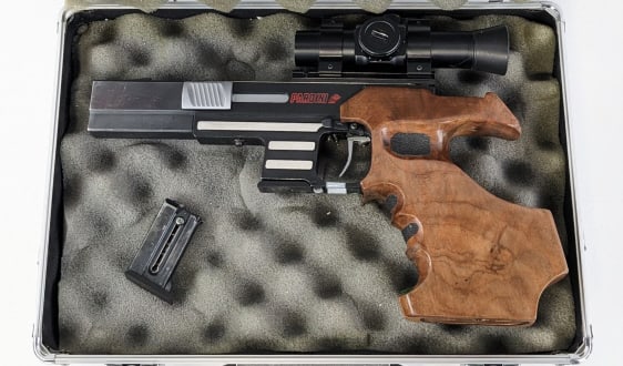 Pardini Fiocchi SP .22 LR Semi Auto Comp Pistol: Pardini Fiocchi .22 LR Semi Auto Competition Pistol. Comes in a case with an extra magazine and features a 5in barrel, unmarked scope, matte black finish with polished accents, and ergonomic wood grip