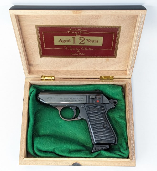 Walther Model PPK/S 9mm Kurz / .380 ACP Pistol: Walther Model PPK/S 9mm Kurz / .380 ACP Pistol. Comes in a cigar box display and features a 3-1/4in barrel, importer marked on the right side of the slide, blued finish, and black checkered plastic gr