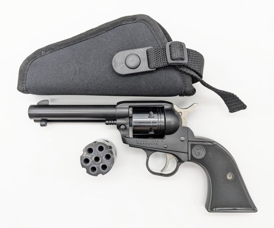 Ruger Wrangler .22 LR 6-Shot Revolver: Ruger Wrangler .22 LR 6-Shot Revolver. Comes in a holster with an extra .22 LR cylinder. Features a 4-5/8in barrel, matte black finish, and checkered black plastic grips. Revolver is in very nice cond