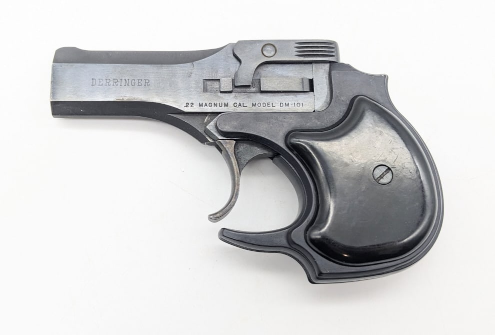 High Standard DM-101 .22 Mag Derringer: High Standard DM-101 .22 Mag Derringer. Features 3-1/2in barrels, blued finish, and smooth black plastic grips. Pistol is in very nice condition with light wear from use and handling. FFL Required for