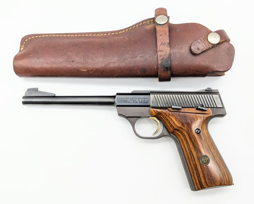 Browning Challenger II .22 LR Semi Auto Pistol: Browning Challenger II .22 LR Semi Auto Pistol. Comes with a leather holster and features a 6-3/4in barrel, blued finish, and smooth wood grips. Pistol is in nice condition with finish wear on the sli