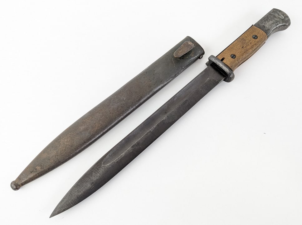 WWII German K98 Bayonet w/ Scabbard: WWII German K98 Bayonet w/ Scabbard. Bayonet is made by Eickhorn in 1943 and features a blackened finish blade and wood handle scales. The serial numbers match the scabbard. Bayonet is in very nice co