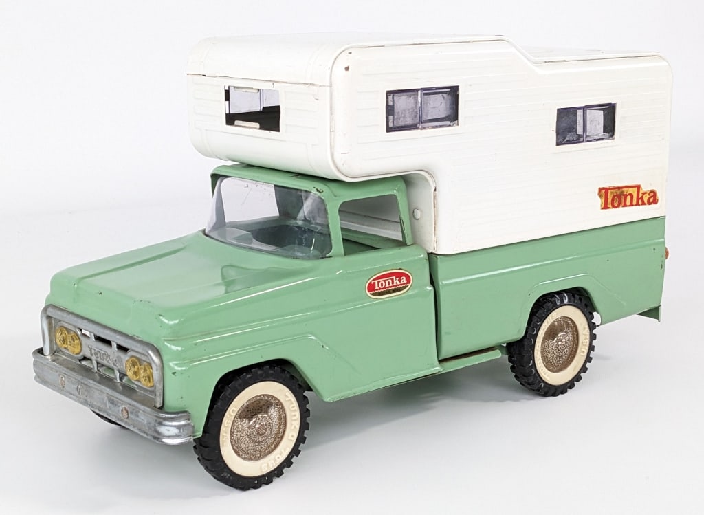 Original Tonka Green Camper Truck: Original Tonka green camper truck. The truck has some rub marks on the tape and discoloration to the decals. It is missing the front plastic window. Measures approximately 14" long.