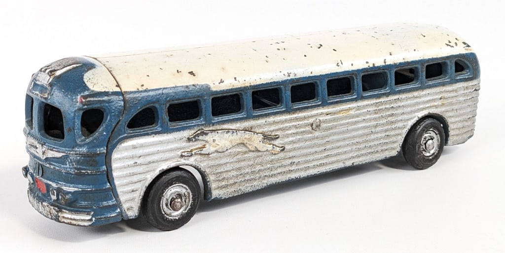 Arcade No. 4400 Greyhound Cruiser Coach Bus: Circa 1941 - Arcade No. 4400 cast iron Greyhound Cruiser Coach bus. The bus has scattered paint loss and age wear. An Arcade decal is barely visible on the bottom of the bus. Measures approximately 9"