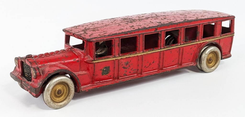 Arcade Cast Iron Fageol Safety Coach Bus: Circa 1925 - Arcade cast iron Fageol Safety Coach bus. The bus has solid metal wheels and nickeled driver. The bus still retains most of the original decal on the bus near the driver. It does have sca