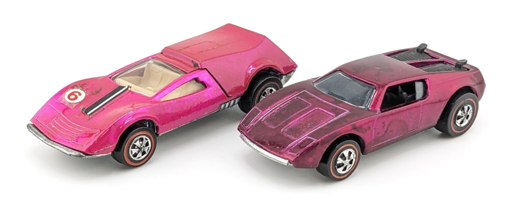 Hot Wheels Redline AMX/2 & Tri-Baby: Hot Wheels Redline magenta AMX/2 and pink Tri-Baby. The AMX/2 is overall a very clean car with some toning to the roof and base. The Tri-Baby has some residue from a decal on the hood and light wear.