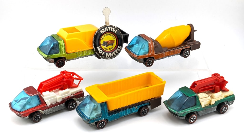 (5) Hot Wheels Redline Heavyweights Trucks: (5) Hot Wheels Redline "The Heavyweights" trucks. Includes red snorkel, green snorkel, orange cement mixer, green waste wagon, and aqua dump truck. The green snorkel truck has damage to the plastic bu