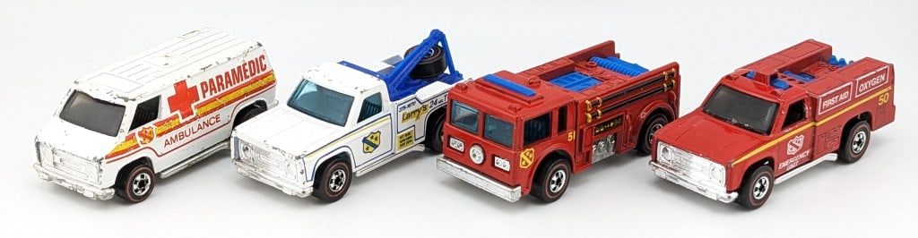 (4) Hot Wheels Redline Fire Trucks & Tow Truck: (4) Hot Wheels Redline cars. Includes red Fire-Eater, white Paramedic / Ambulance, red Emergency Unit truck, and white Larry's 24 hr. Towing service truck. All have some paint loss and expected wear f
