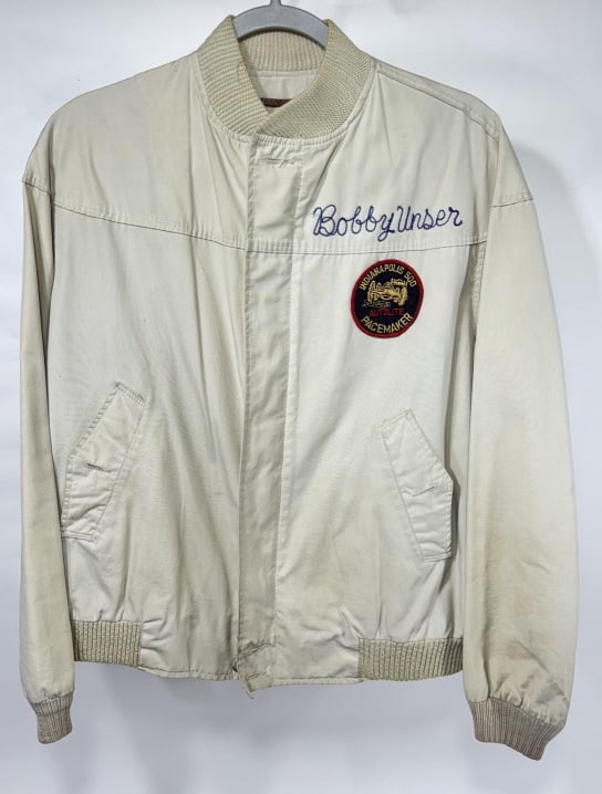 Bobby Unser's Indy 500 Autolite Pacemaker Jacket: Bobby Unser's Autolite Indianapolis 500 Pacemaker jacket. It features Unser's chain stitched name and original Auto Lite Indy 500 Pacemaker patch. Appears to be in overall good condition with some dis