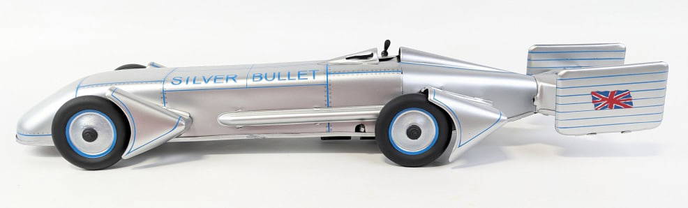 Restored Gunthermann Silver Bullet Racer: Restored Gunthermann Silver Bullet tin windup racer. The racer has been restored at sometime and may have replacement parts. The windup mechanism works. It is missing the driver. Measures approximatel