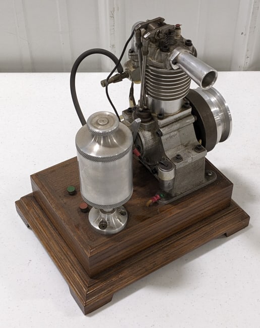 Custom Small Engine Replica On Wood Base: Custom built small engine replica. Engine is untested, but appears to have good compression. Measures approximately 8" tall by 8-1/2" across without the base.