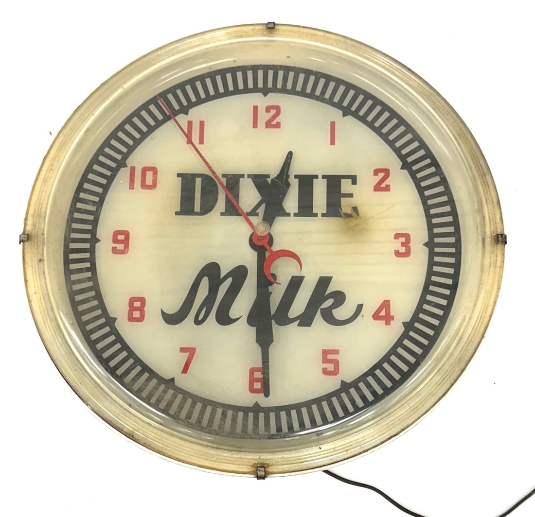 Dixie Milk Lighted Advertising Clock: Dixie Milk Lighted Advertising Clock.? The vintage Dixie Milk Clock is in nice used condition.? The clock has a plastic covering.? The sign when plugged in does not light up but is in working order.?