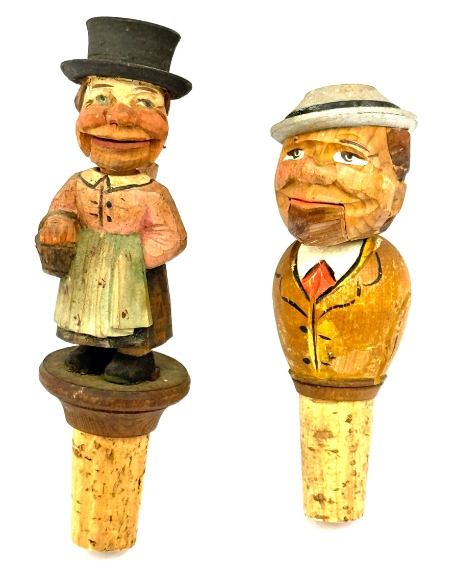 (2) ANRI Black Forest Hand Carved Yakker Bottle Stoppers: (2) ANRI Black Forest Hand Carved Yakker Bottle Stoppers. These Hand Carved Wood Bottle Stoppers Have A Wooden Mechanical Feature To Allow The Mouth To Open And Close The Figurals Depict Local. The Fe