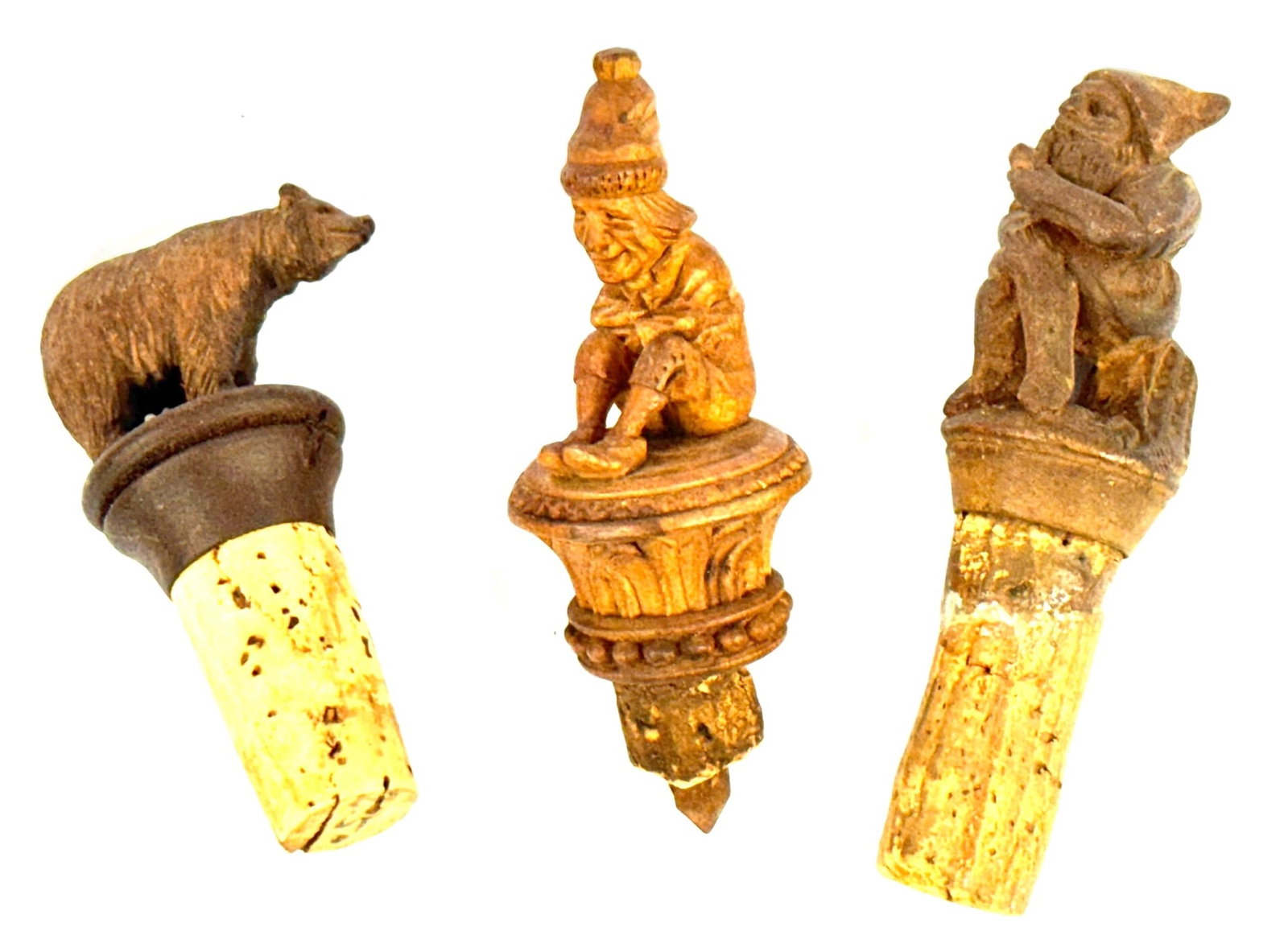 (3) Black Forest Hand-Carved Bottle Stoppers, Including A Bear And 2 Gnomes: (3) Black Forest Hand-Carved Bottle Stoppers, Including A Bear And 2 Gnomes. This Lot Contains Intricately Carved Black Forest Wood Gnomes On Bases and One Carved Bear. The Pipe Smoking Gnome Is Signe