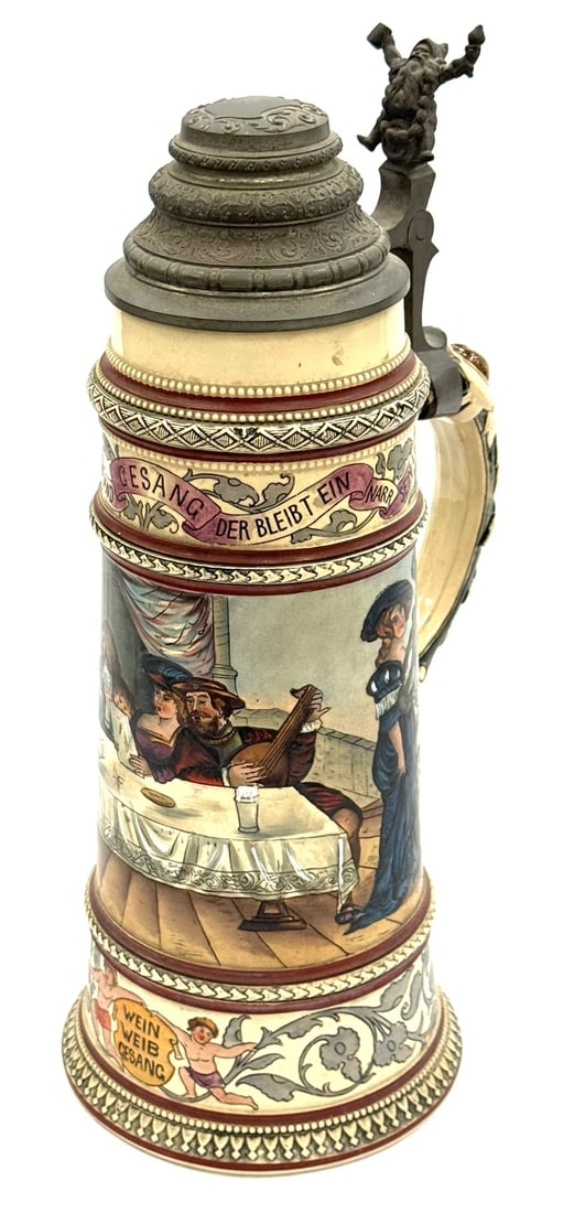 3 1/2 Liter German Wein Weib Gesang Stein: 3 1/2 Liter German Wein Weib Gesang Stein. This Ornate Stein Is In Very Good Condition. It Has A Domed Pewter Lid Depicting A Gnome On The Thumb Flip, Scroll Work and A Blank Crest Ready For Inscripti