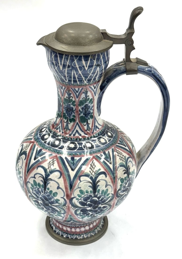 German Westerwald Glazed Pitcher with Pewter Lid and Bottom Rim: German Westerwald Glazed Pitcher with Pewter Lid and Bottom Rim. This Pitcher Is In Very Good Condition. The Measurements Are 12" x 8" x 7".